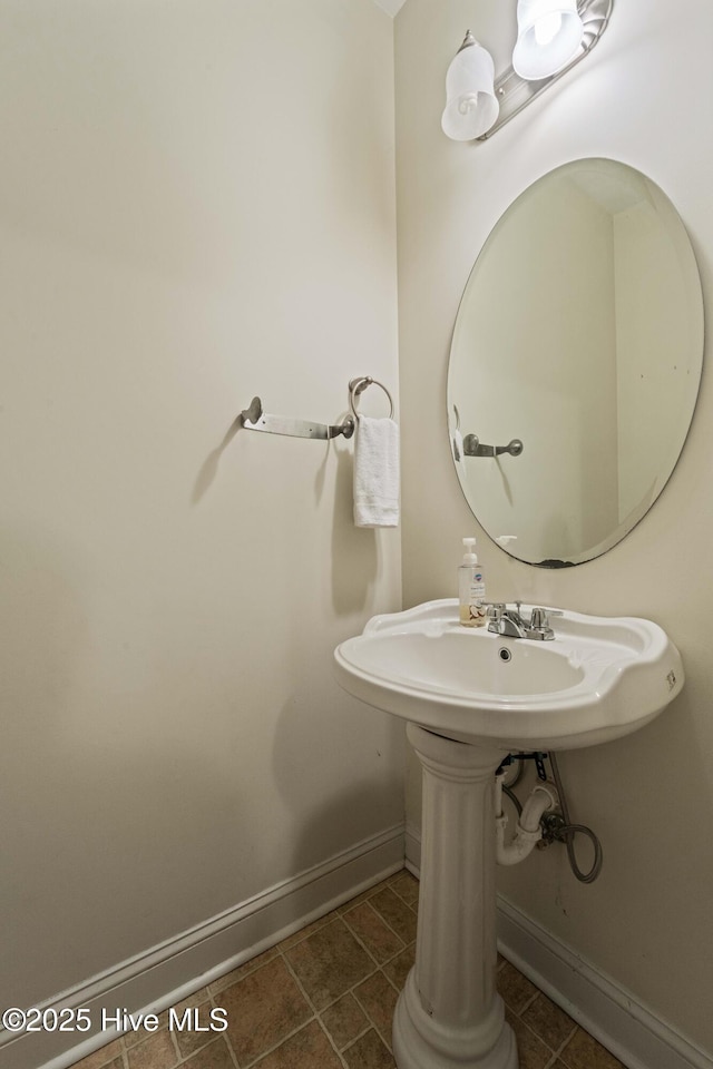 bathroom featuring tile patterned flooring and baseboards