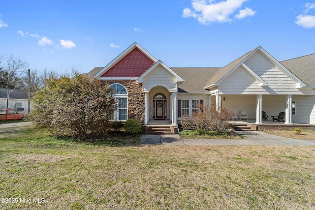 view of front of property featuring stone siding and a front yard