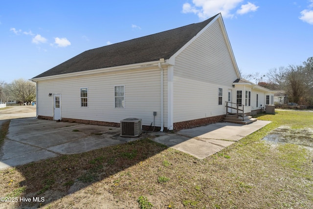 rear view of house featuring central air condition unit and a patio