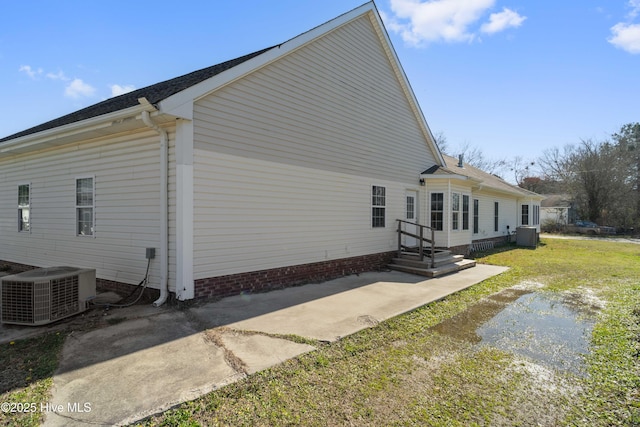 view of side of home featuring central AC unit and a patio