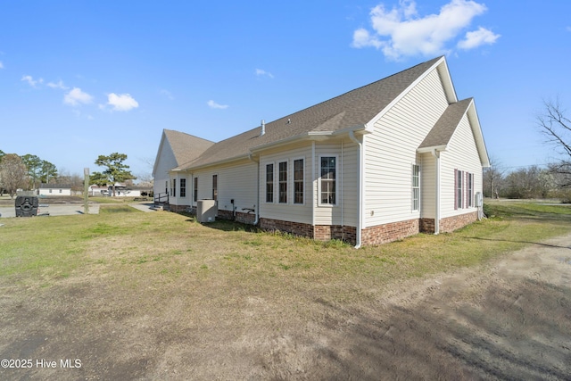 view of property exterior with cooling unit, a yard, and roof with shingles