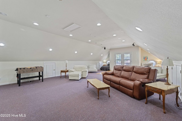 living room featuring baseboards, a textured ceiling, lofted ceiling, and carpet flooring