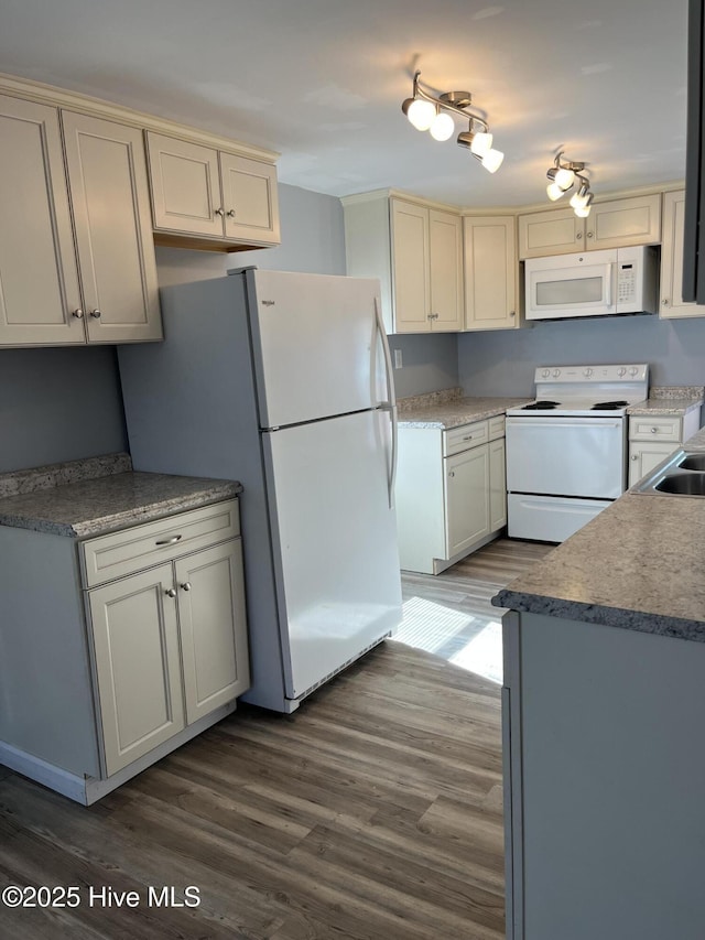 kitchen with white appliances and dark wood-type flooring