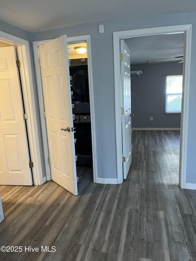 interior space featuring baseboards and dark wood finished floors