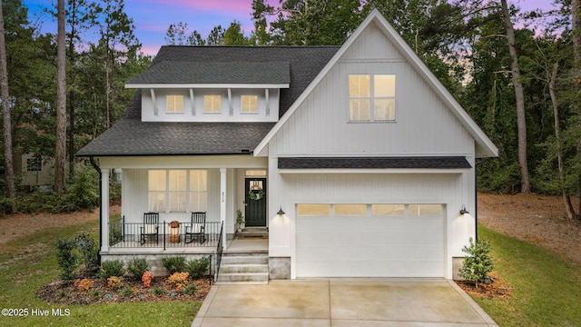 876 Elderberry Dr, Vass, NC 28394 - view of front facade with a shingled roof, a porch, a garage, and concrete driveway