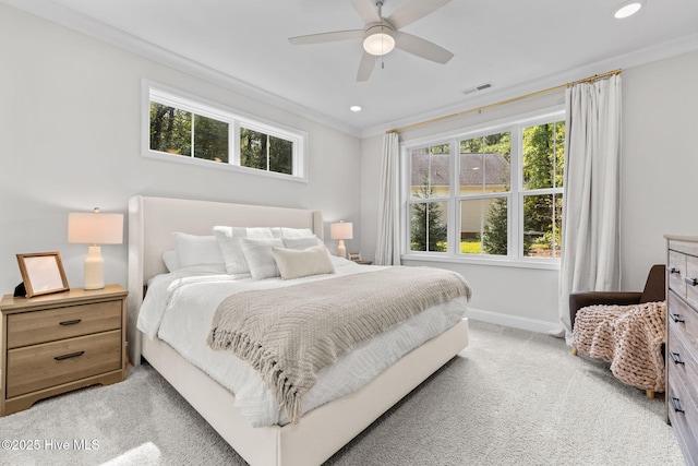 bedroom with light carpet, multiple windows, baseboards, and crown molding