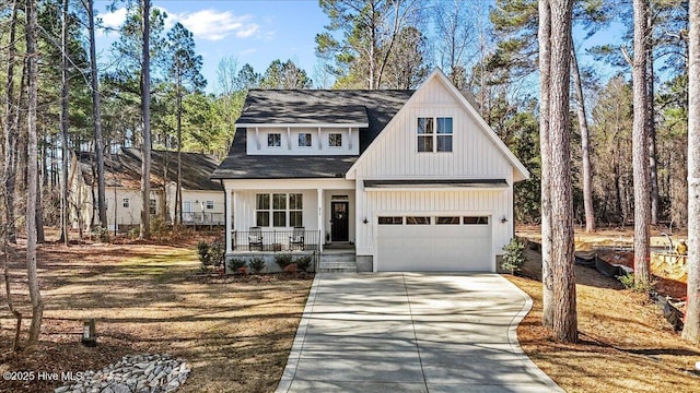 modern farmhouse with a porch and concrete driveway