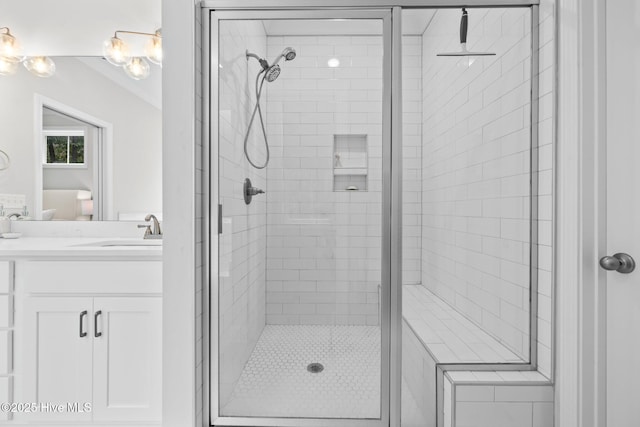 full bathroom featuring a shower stall and vanity