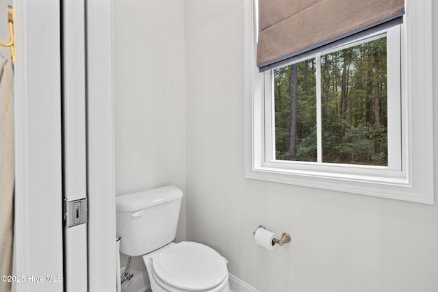 bathroom featuring toilet and baseboards