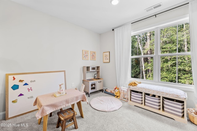 recreation room featuring carpet flooring, visible vents, and baseboards