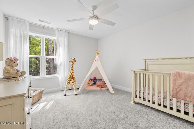 876 Elderberry Dr, Vass, NC 28394 - carpeted bedroom featuring baseboards, a ceiling fan, visible vents, and a nursery area