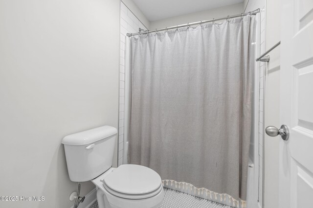 876 Elderberry Dr, Vass, NC 28394 - bathroom with toilet and a shower with shower curtain
