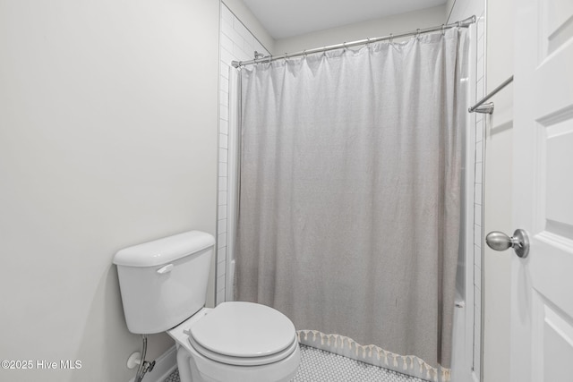 bathroom with a shower with shower curtain and toilet