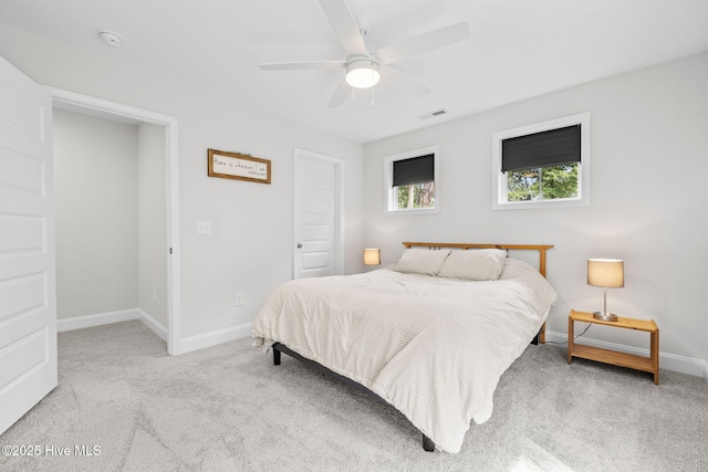 bedroom with ceiling fan, carpet floors, visible vents, and baseboards