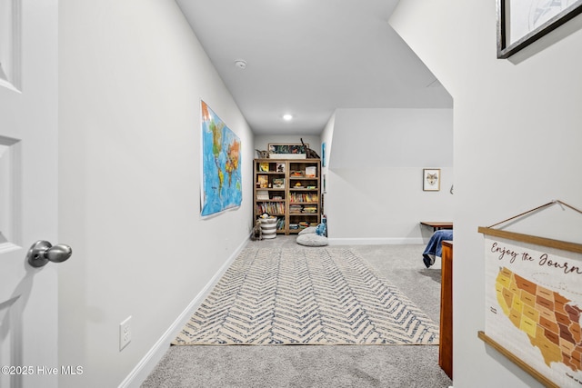 corridor featuring carpet and baseboards