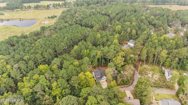 birds eye view of property featuring a water view and a forest view