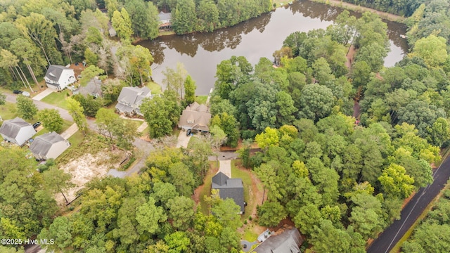 birds eye view of property with a water view and a view of trees