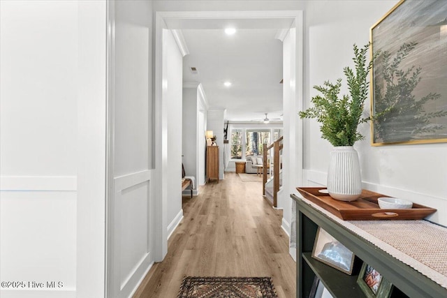 hallway with recessed lighting, baseboards, and light wood finished floors