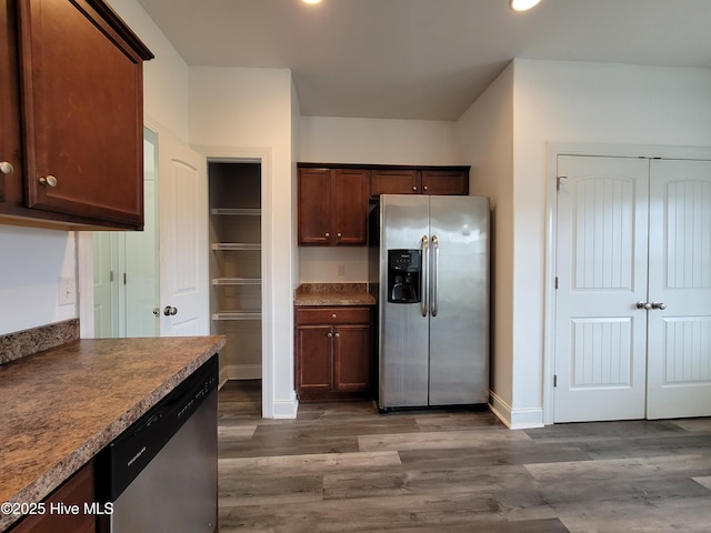 kitchen with stainless steel appliances, baseboards, and dark wood-type flooring