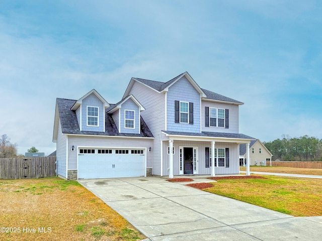 view of front of house with a front lawn, fence, covered porch, concrete driveway, and a garage