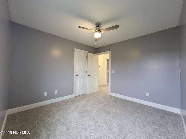 unfurnished room with baseboards, carpet floors, and ceiling fan