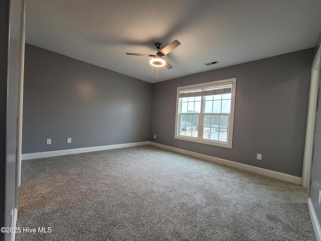 unfurnished room featuring visible vents, ceiling fan, carpet, and baseboards