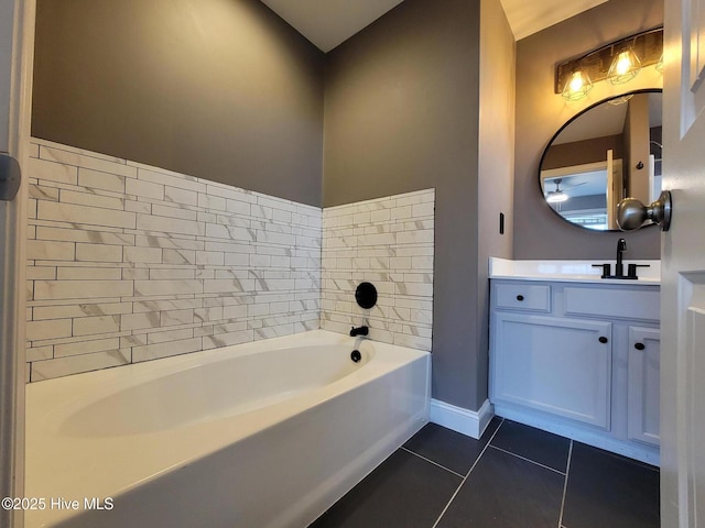 full bath featuring tile patterned floors, a bath, vanity, and baseboards