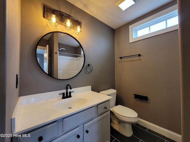 full bathroom featuring toilet, tile patterned flooring, baseboards, walk in shower, and vanity