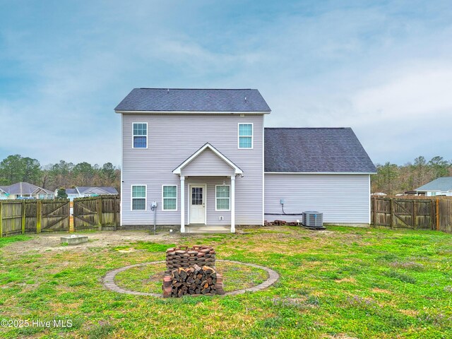 back of property featuring central air condition unit, a lawn, a gate, a fenced backyard, and a patio area