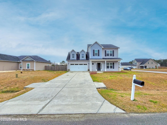 traditional-style house featuring covered porch, concrete driveway, a front lawn, and fence