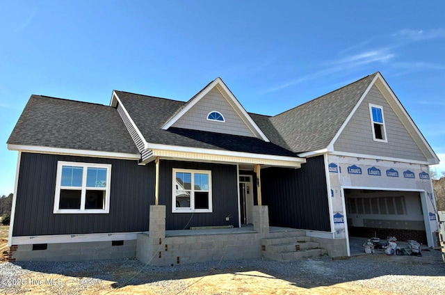 view of front facade featuring covered porch, a garage, driveway, roof with shingles, and crawl space