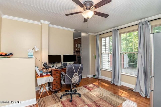 office space featuring visible vents, baseboards, crown molding, and wood finished floors