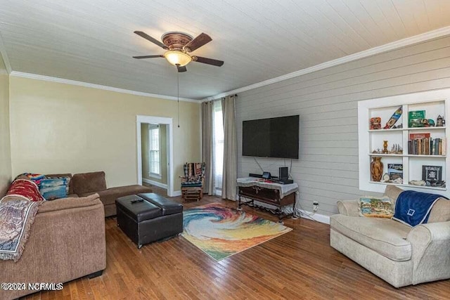 living room with ceiling fan, ornamental molding, and wood finished floors