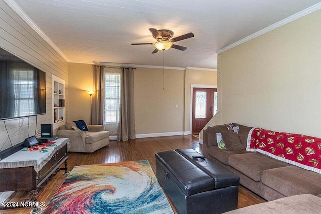 living room with ornamental molding, a ceiling fan, plenty of natural light, and wood finished floors