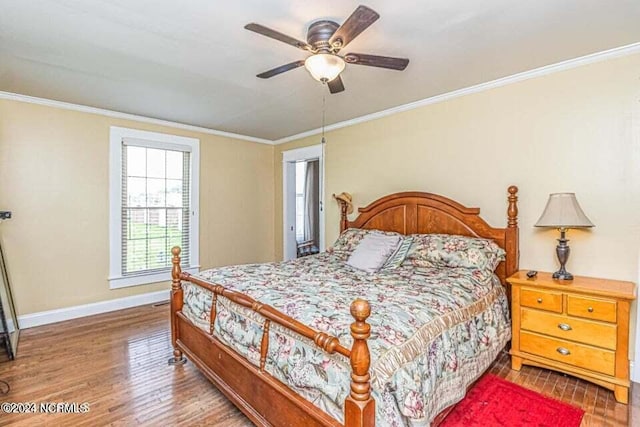 bedroom featuring baseboards, ceiling fan, wood finished floors, and crown molding