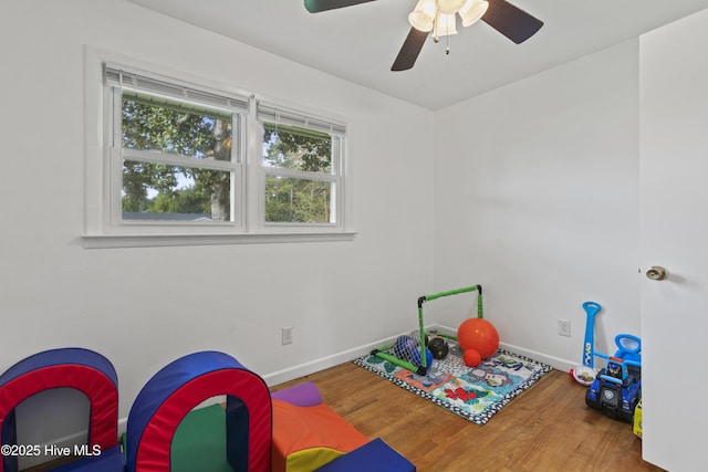 game room featuring a ceiling fan, baseboards, and wood finished floors