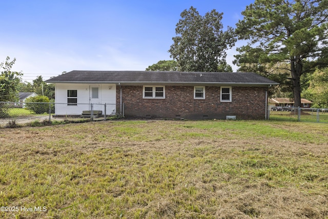 rear view of house featuring crawl space, fence, a lawn, and brick siding