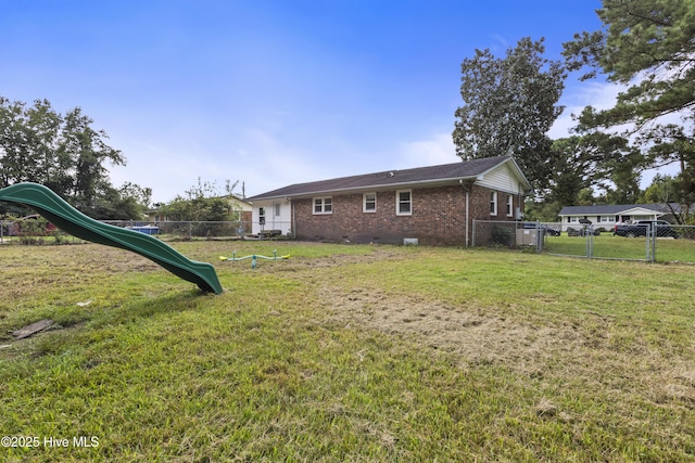 view of yard featuring a playground and fence