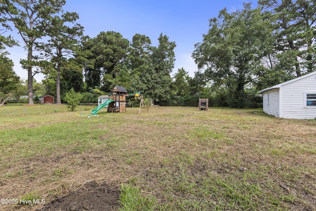 view of yard featuring a playground and fence