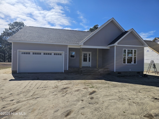 view of front of home with crawl space, a garage, and roof with shingles