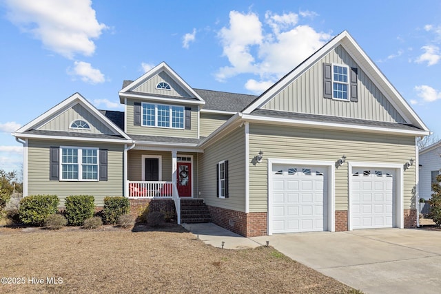 view of front of home featuring concrete driveway, roof with shingles, an attached garage, covered porch, and board and batten siding