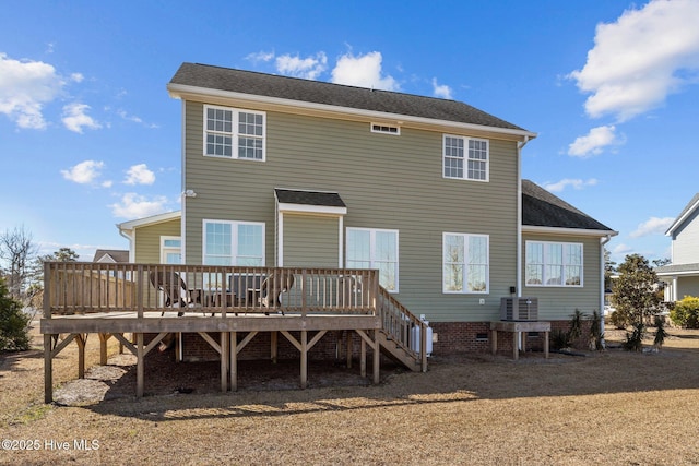 rear view of property featuring a wooden deck and stairs