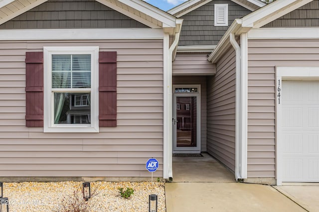 property entrance featuring an attached garage