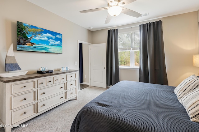 bedroom featuring ceiling fan, visible vents, and light colored carpet