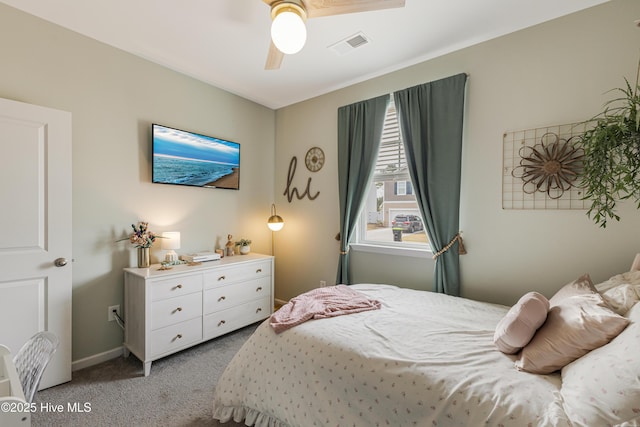 bedroom with a ceiling fan, light colored carpet, visible vents, and baseboards