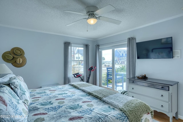 bedroom with ornamental molding, light wood-style floors, ceiling fan, and a textured ceiling