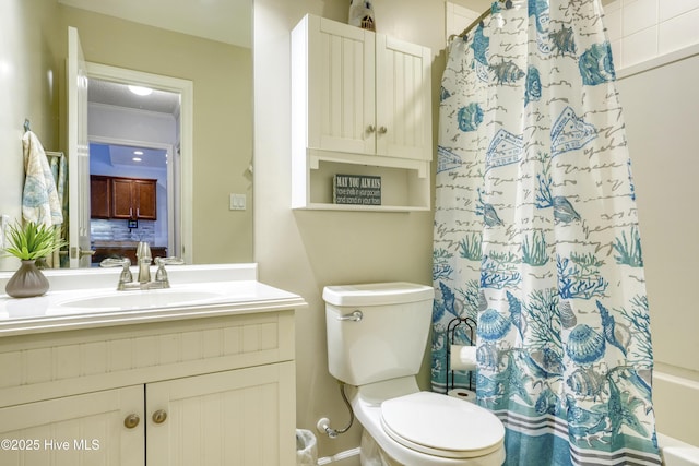 bathroom with ornamental molding, vanity, and toilet