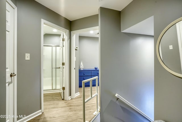 hall featuring baseboards and wood finished floors