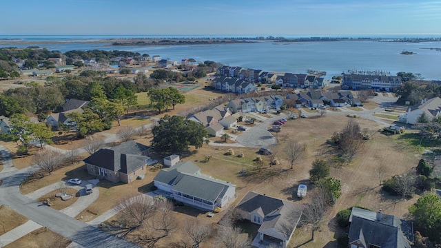 drone / aerial view featuring a water view and a residential view