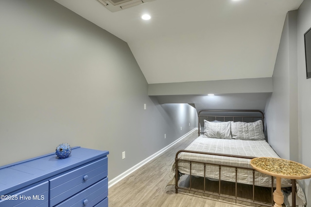 bedroom featuring recessed lighting, visible vents, baseboards, vaulted ceiling, and light wood finished floors